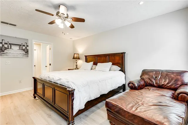 a bedroom with bed and a couch