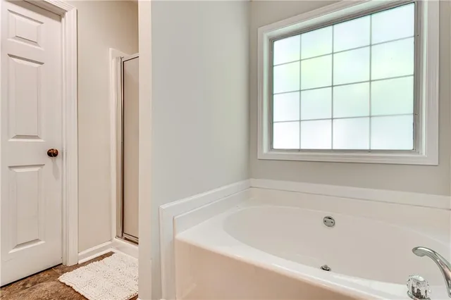 a white bath tub sitting next to a white sink