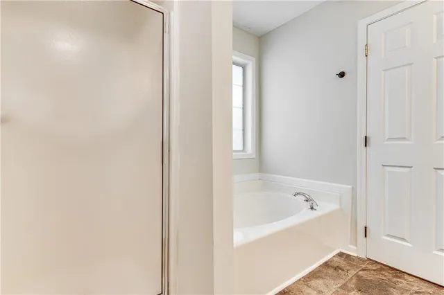 a bedroom with two bed and window