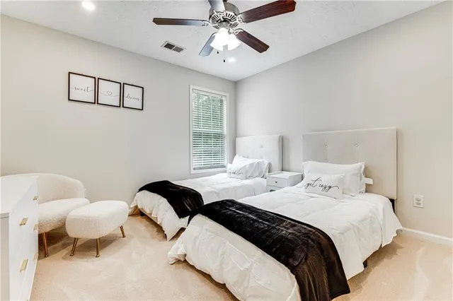 a bedroom with a bed and painting on the wall