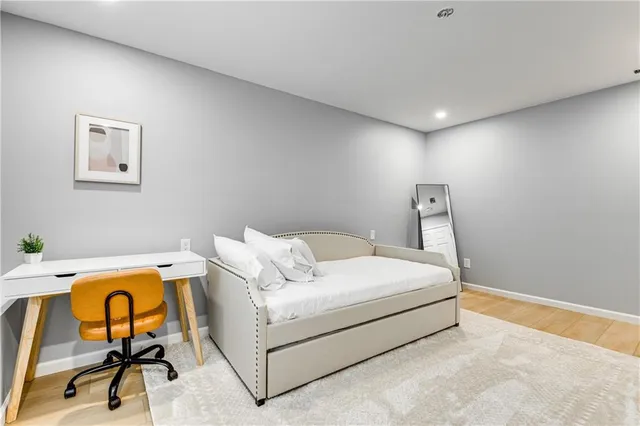 a spacious bedroom with a bed and a large window