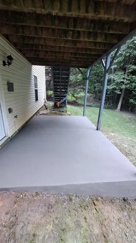 a view of a patio with a table and chairs under an umbrella