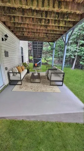 a view of a house with backyard and sitting area