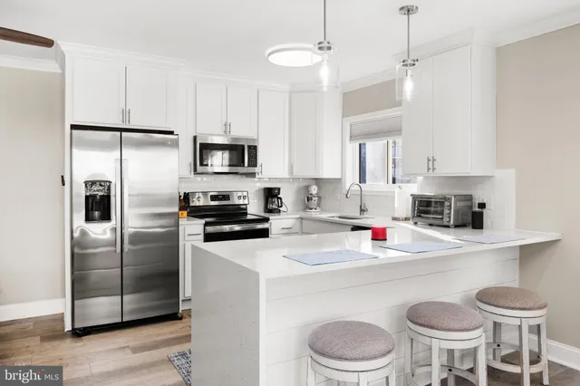 a kitchen with a white cabinets and stainless steel appliances