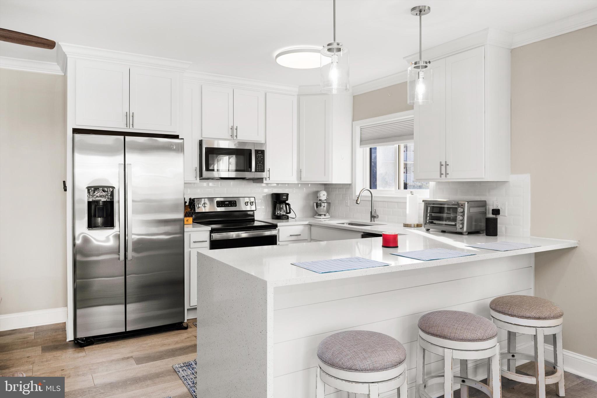 a kitchen with a white cabinets and stainless steel appliances