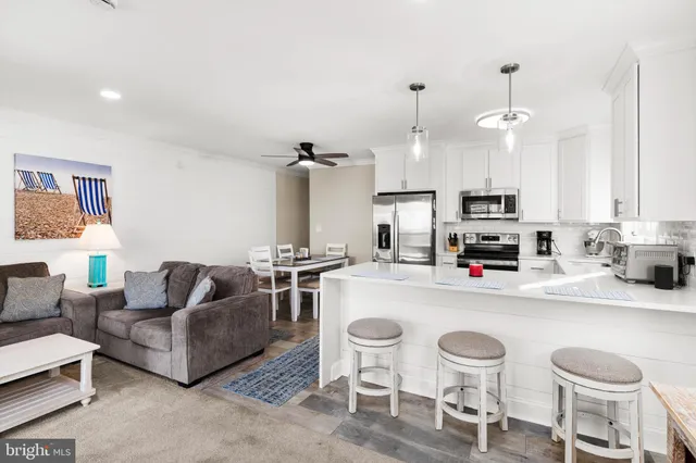a kitchen with stainless steel appliances a stove a sink and a microwave