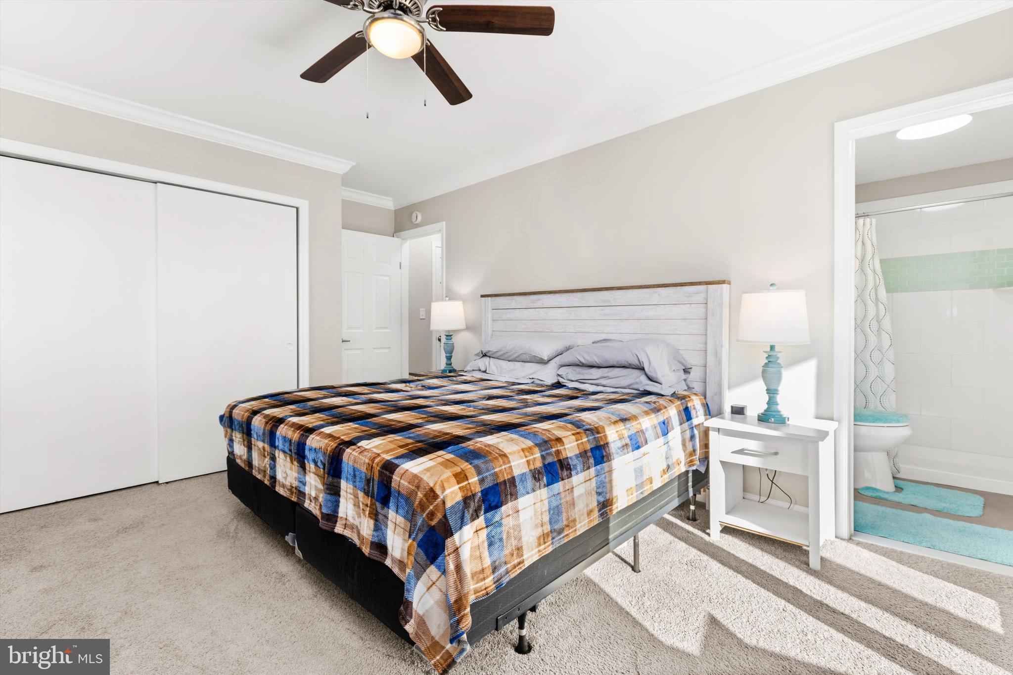 9 64th Street, Unit 304 Ocean City, MD 21842 - Photo 18 of 41 a bedroom with a bed and ceiling fan