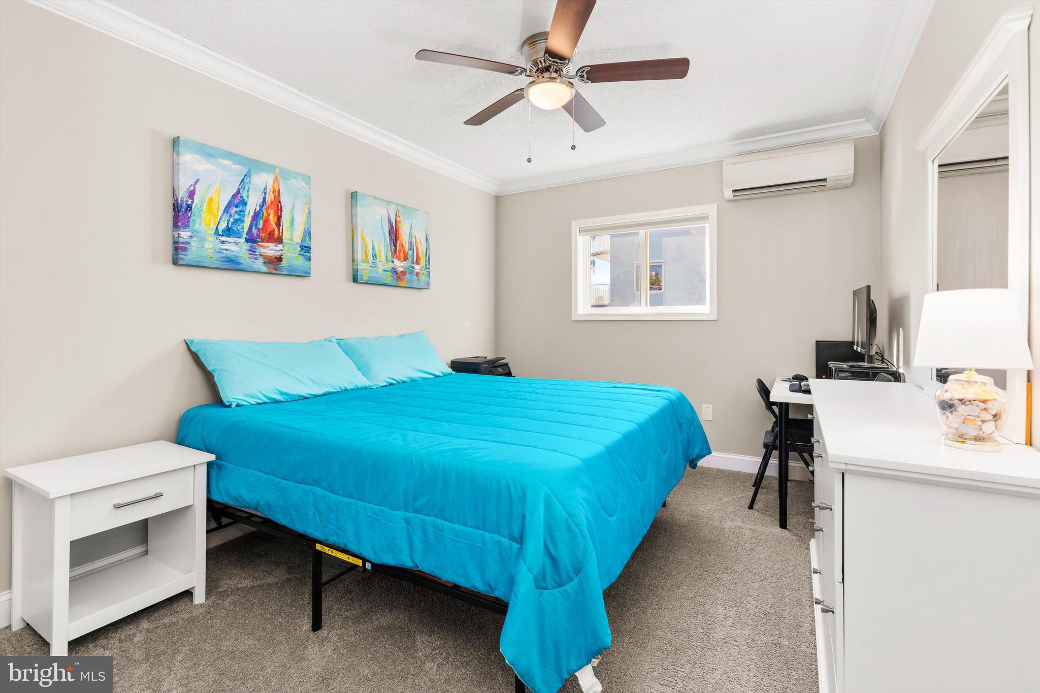 9 64th Street, Unit 304 Ocean City, MD 21842 - Photo 25 of 41 a bedroom with a bed and a table