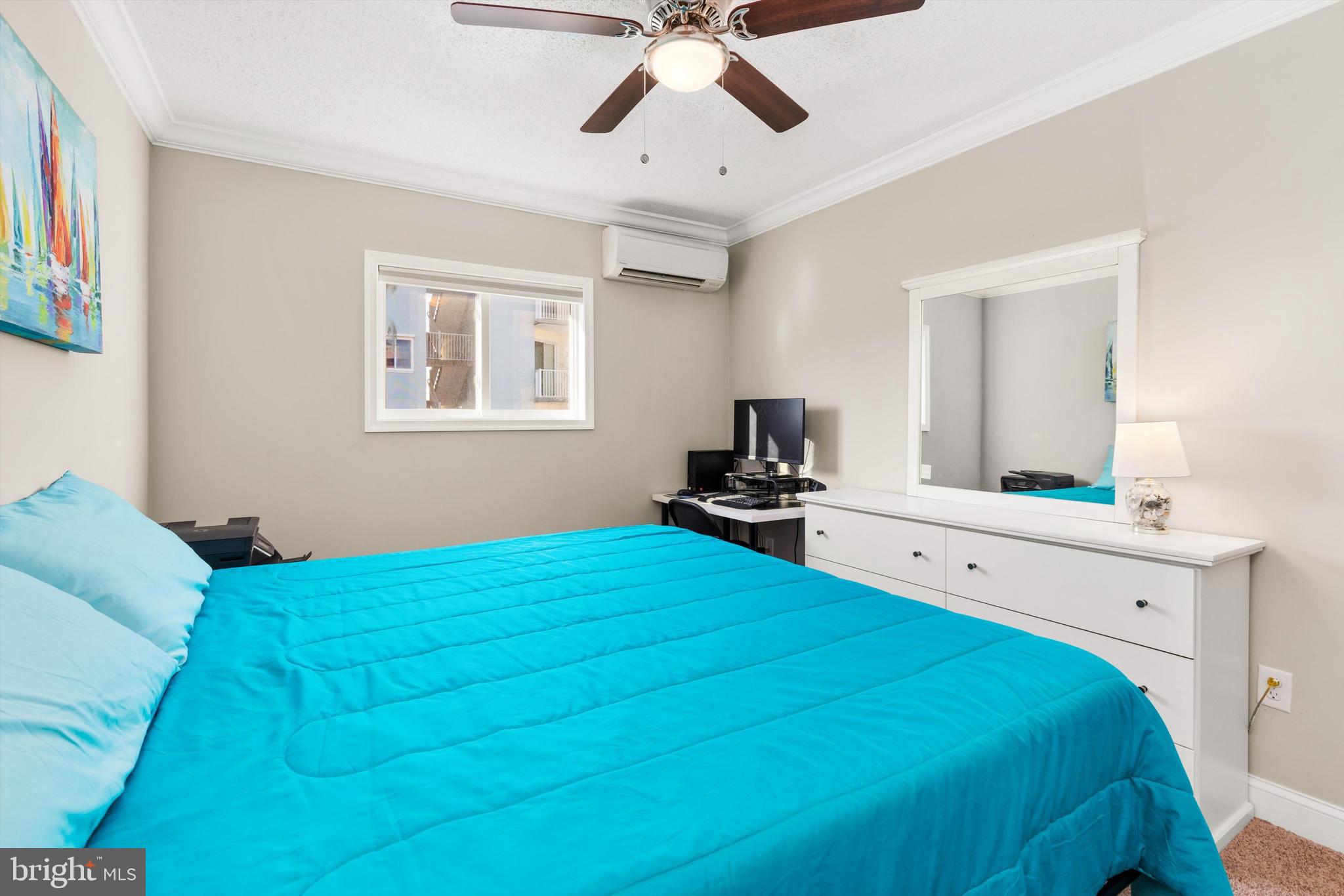 9 64th Street, Unit 304 Ocean City, MD 21842 - Photo 26 of 41 a bedroom with a bed and a chandelier