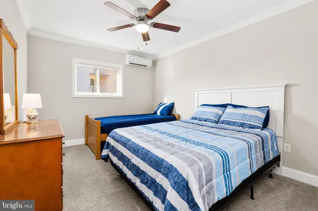 a bedroom with two beds and painting on the wall