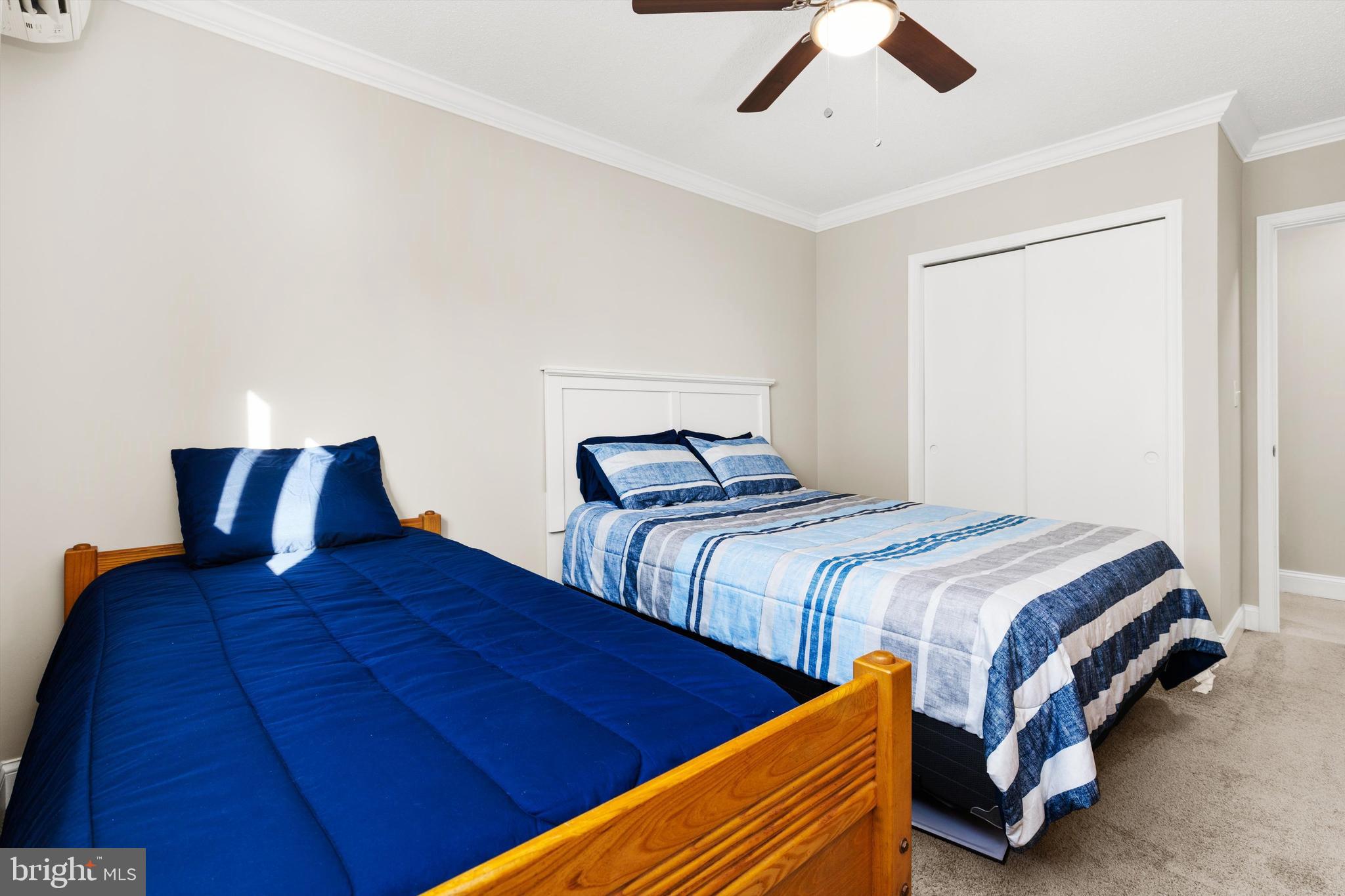 9 64th Street, Unit 304 Ocean City, MD 21842 - Photo 28 of 41 a bedroom with two beds and painting on the wall