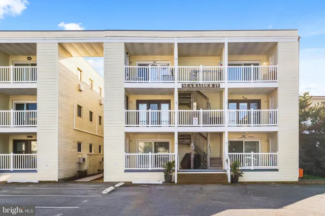 a front view of a building with a garden