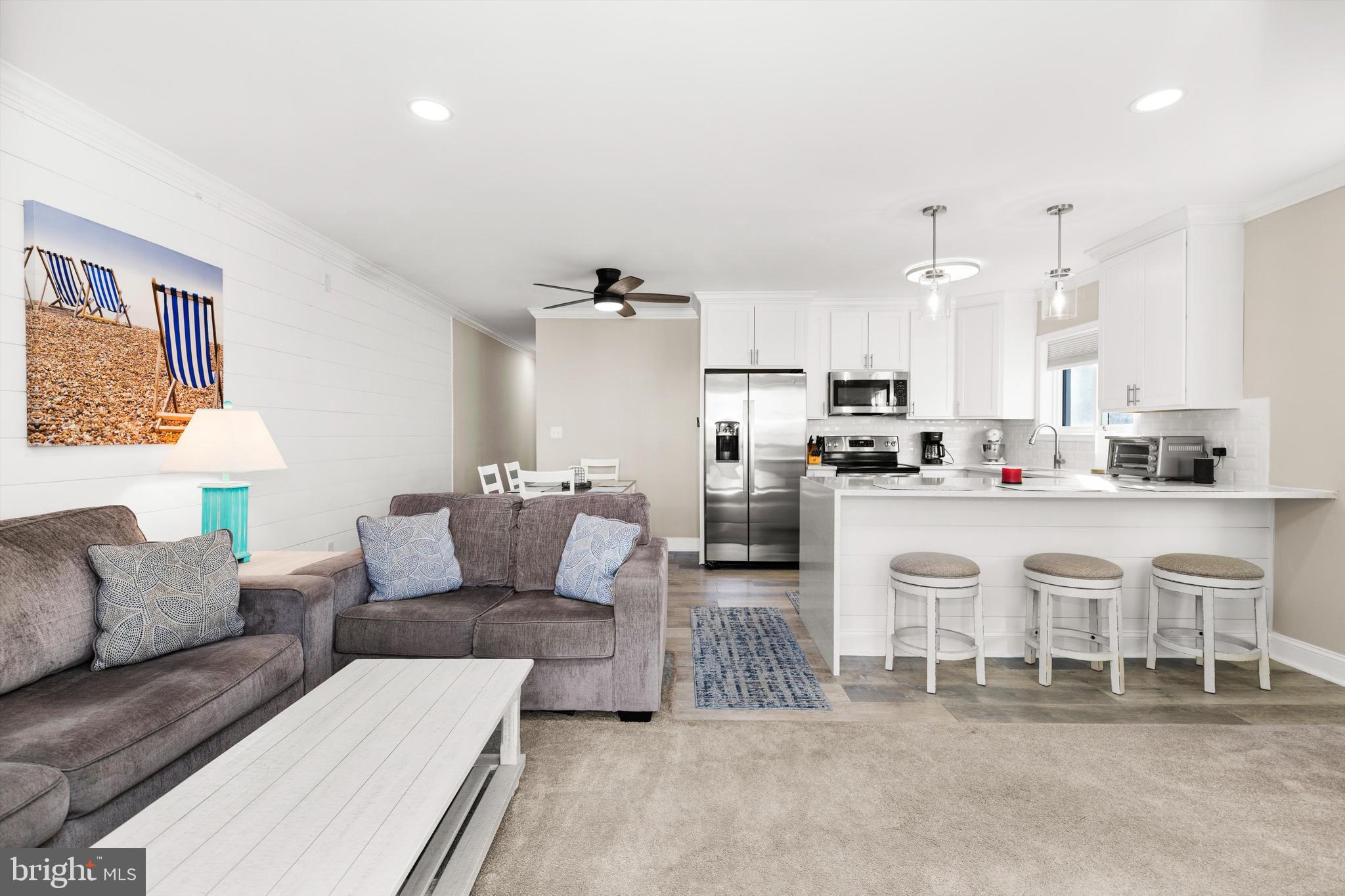 9 64th Street, Unit 304 Ocean City, MD 21842 - Photo 3 of 41 a living room with furniture and kitchen view