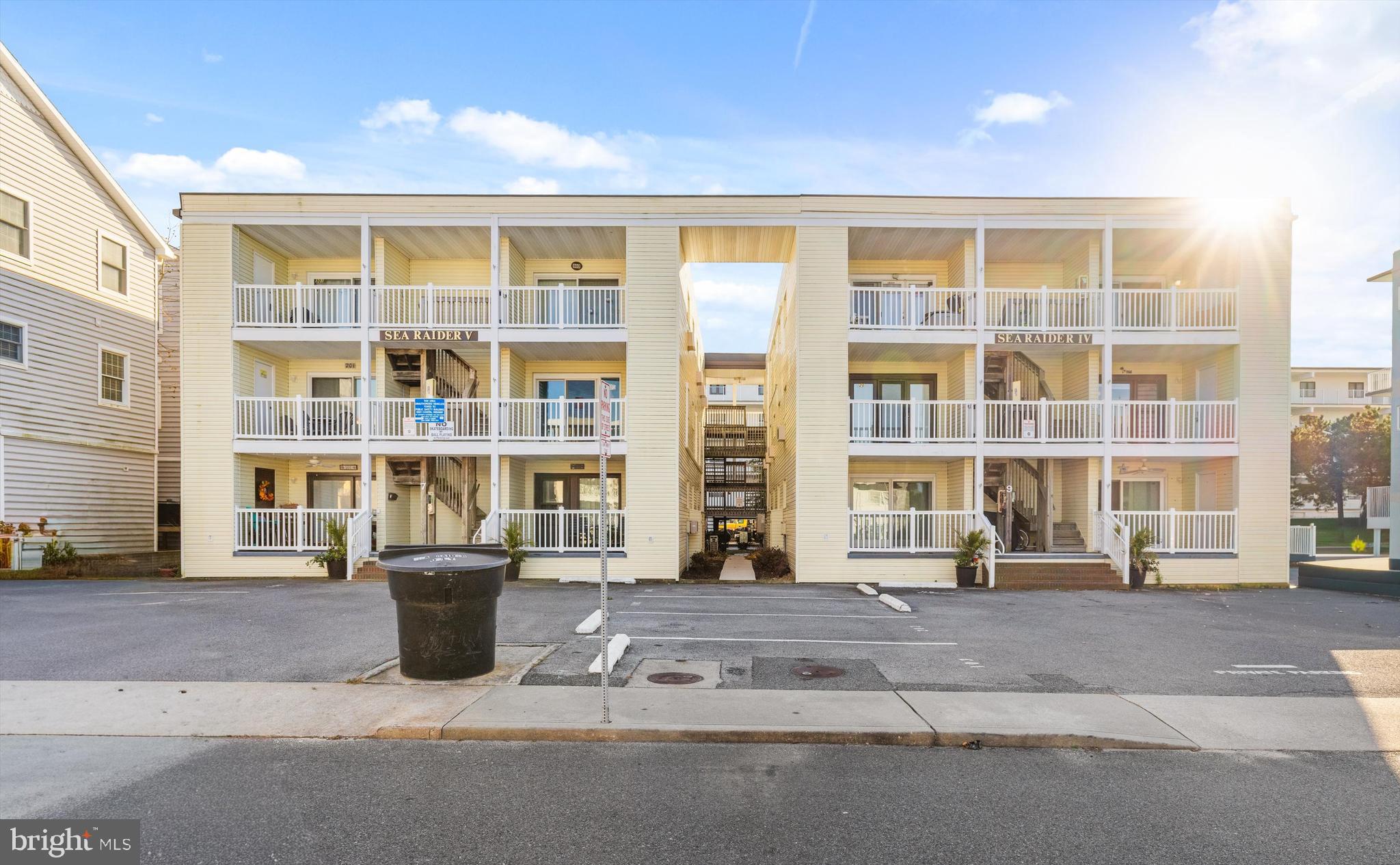 9 64th Street, Unit 304 Ocean City, MD 21842 - Photo 31 of 41 a front view of a building with a garden