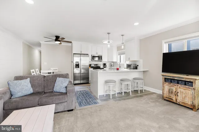 a kitchen with stainless steel appliances a sink cabinets and a window