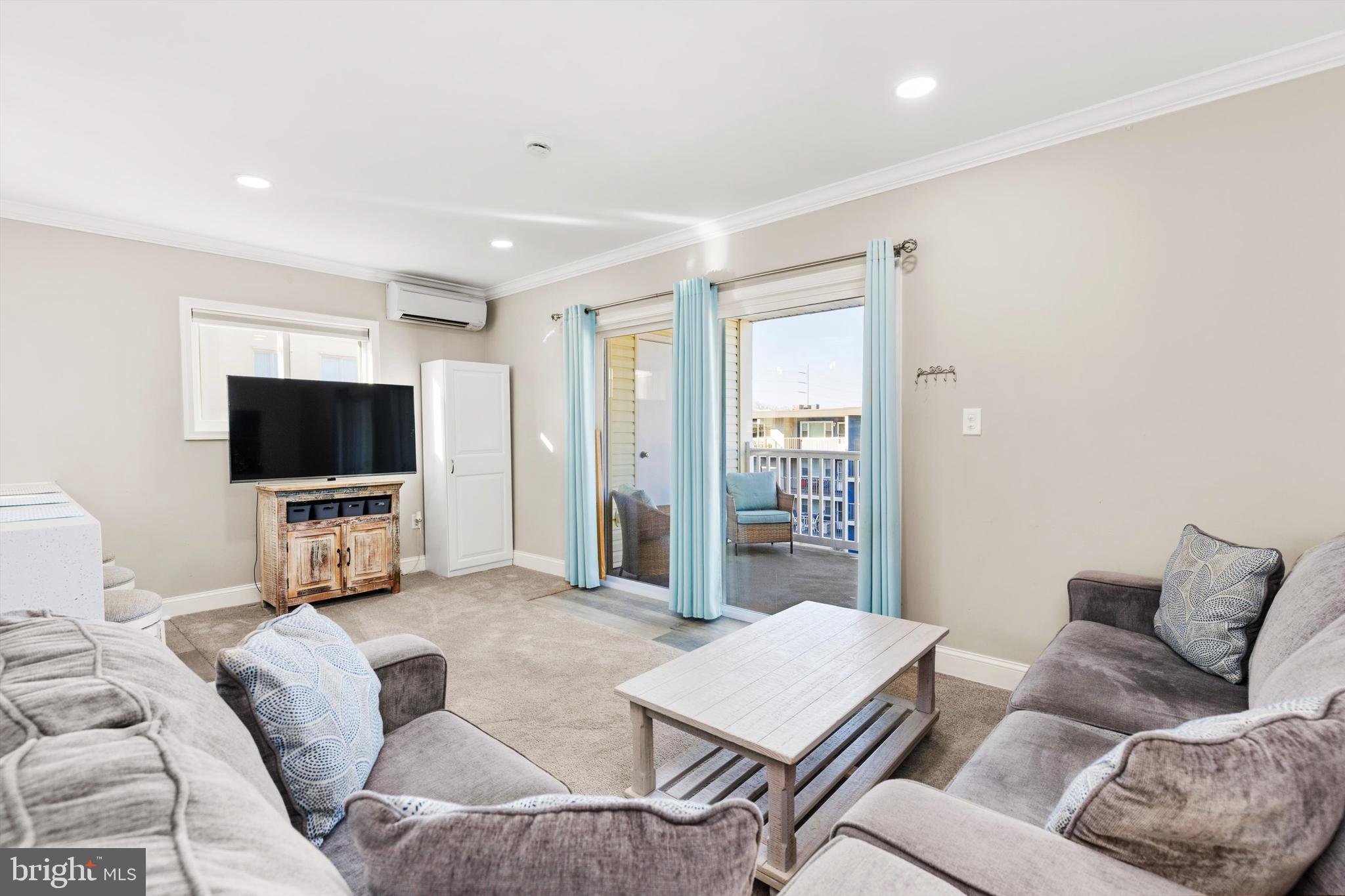 9 64th Street, Unit 304 Ocean City, MD 21842 - Photo 6 of 41 a living room with furniture and a flat screen tv