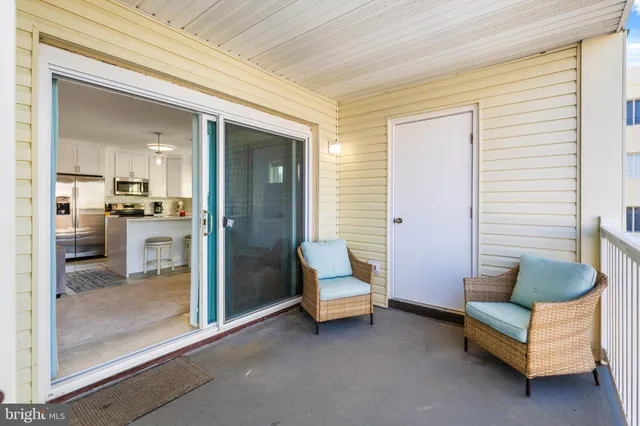 a view of a dining room with furniture and a chandelier
