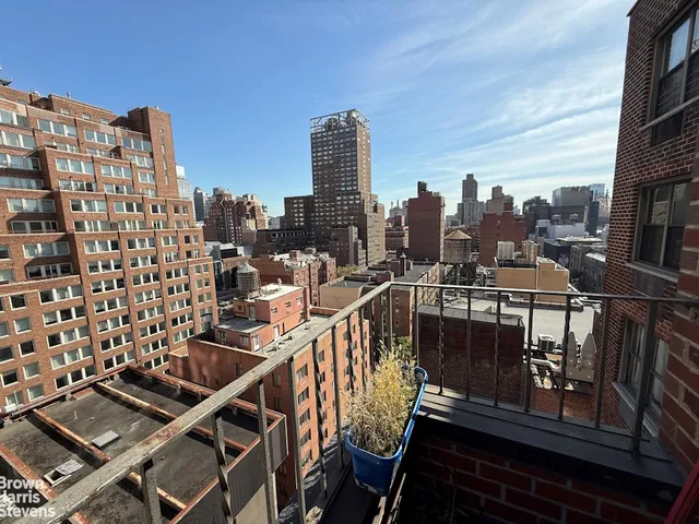 a view of a balcony with wooden benches