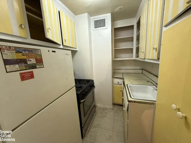 a kitchen with a sink a stove and cabinets