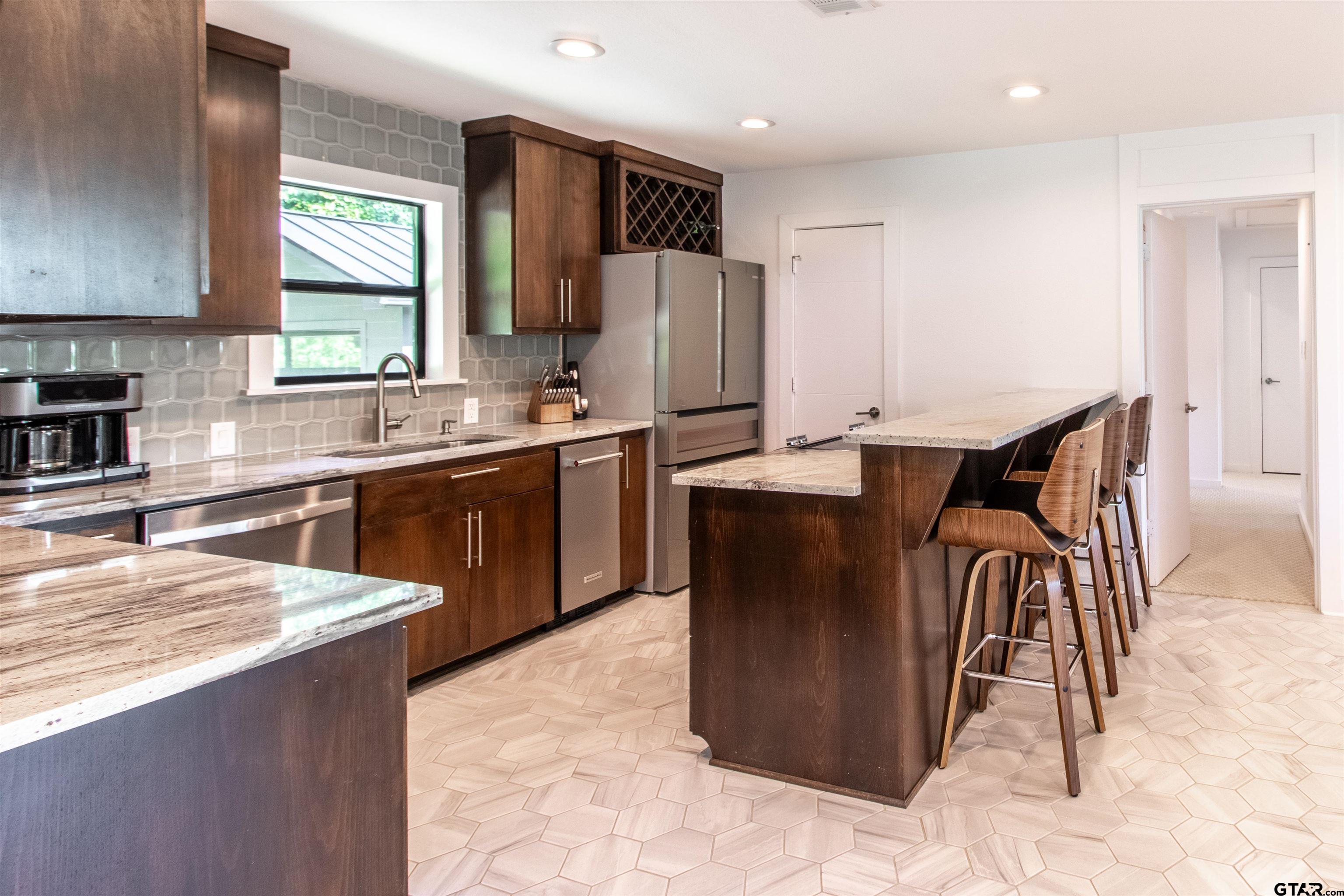 15807 North Peninsula Road Whitehouse, TX 75791 - Photo 15 of 44 a kitchen with stainless steel appliances granite countertop a sink a stove and a refrigerator