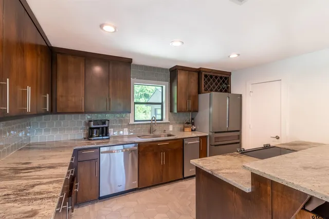 a kitchen with a sink stove and refrigerator
