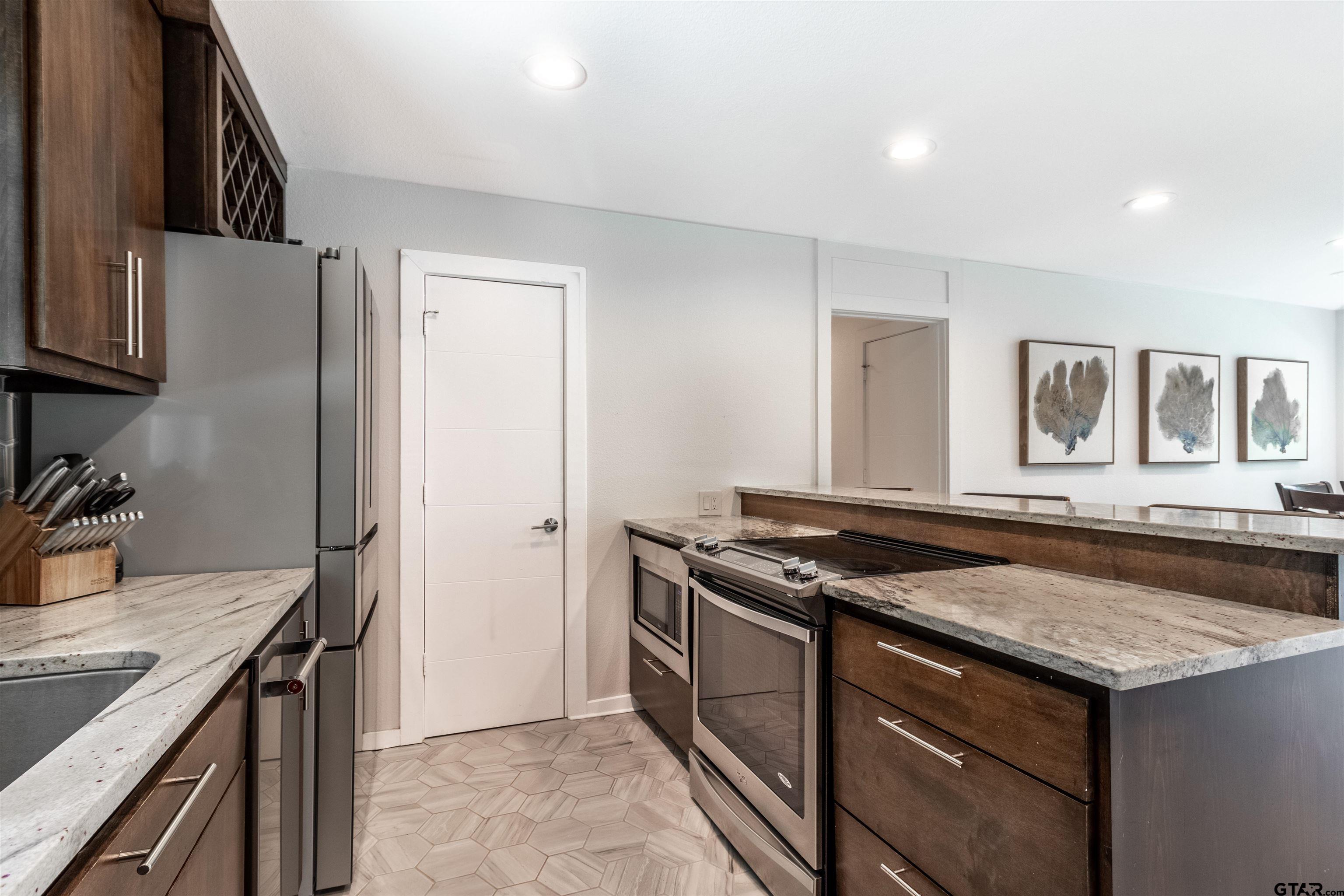 15807 North Peninsula Road Whitehouse, TX 75791 - Photo 18 of 44 a kitchen that has a sink a stove and a refrigerator