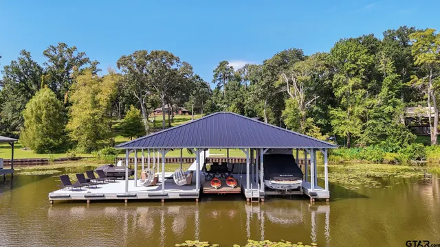 a view of house with swimming pool yard and outdoor seating