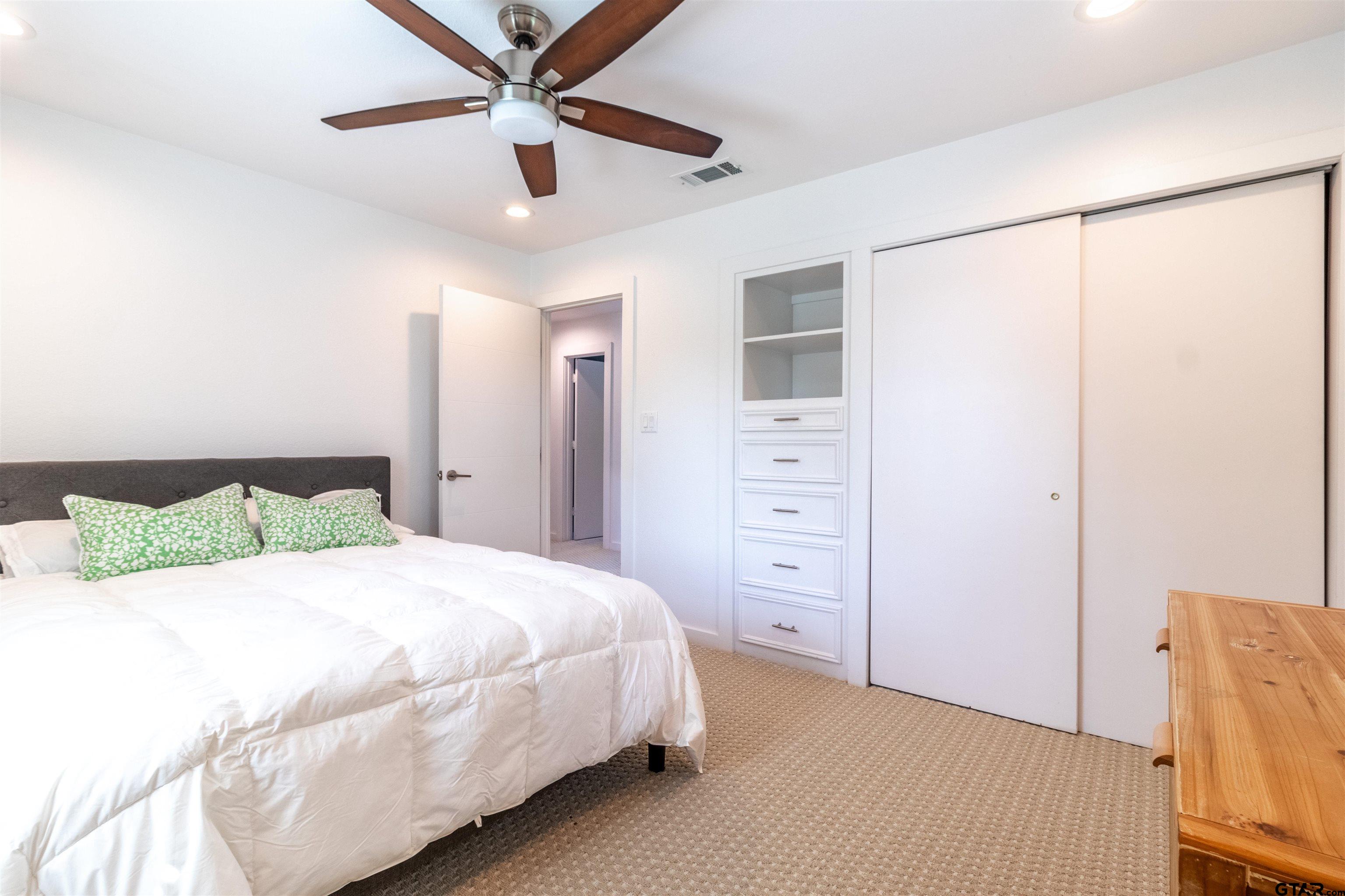 15807 North Peninsula Road Whitehouse, TX 75791 - Photo 23 of 44 a bedroom with a bed and a ceiling fan