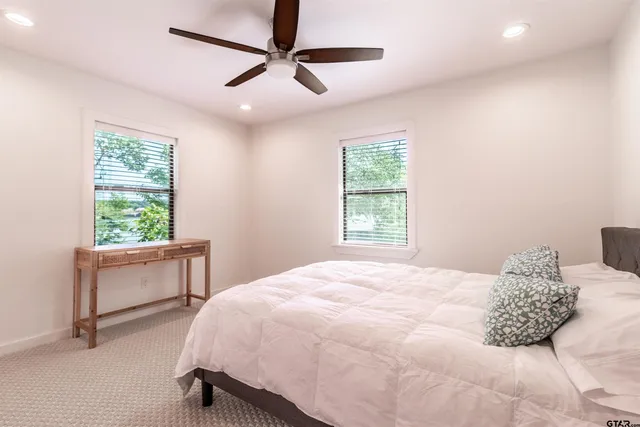 a bedroom with a large bed and a chandelier