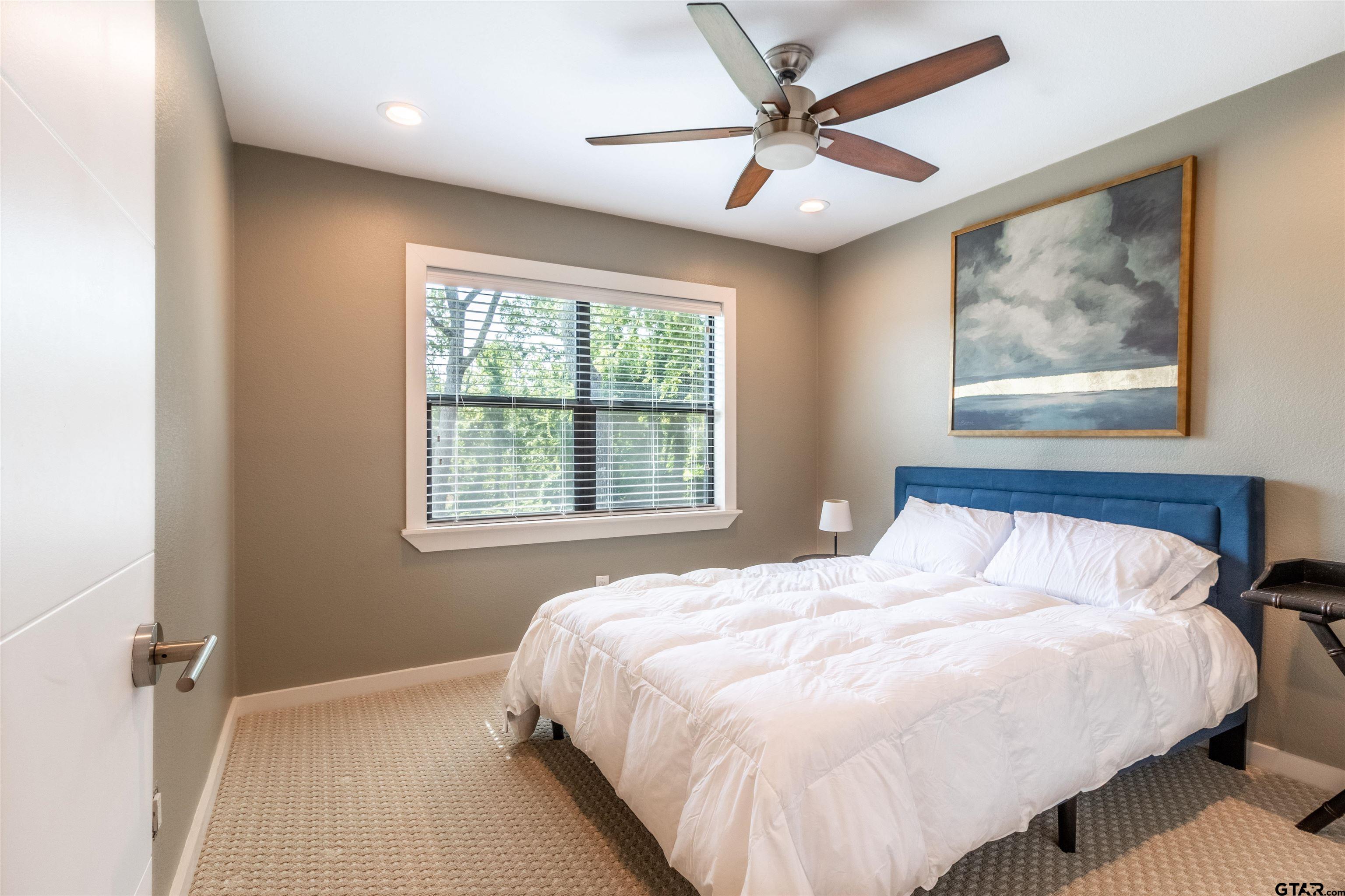 15807 North Peninsula Road Whitehouse, TX 75791 - Photo 25 of 44 a bedroom with a large bed and a window