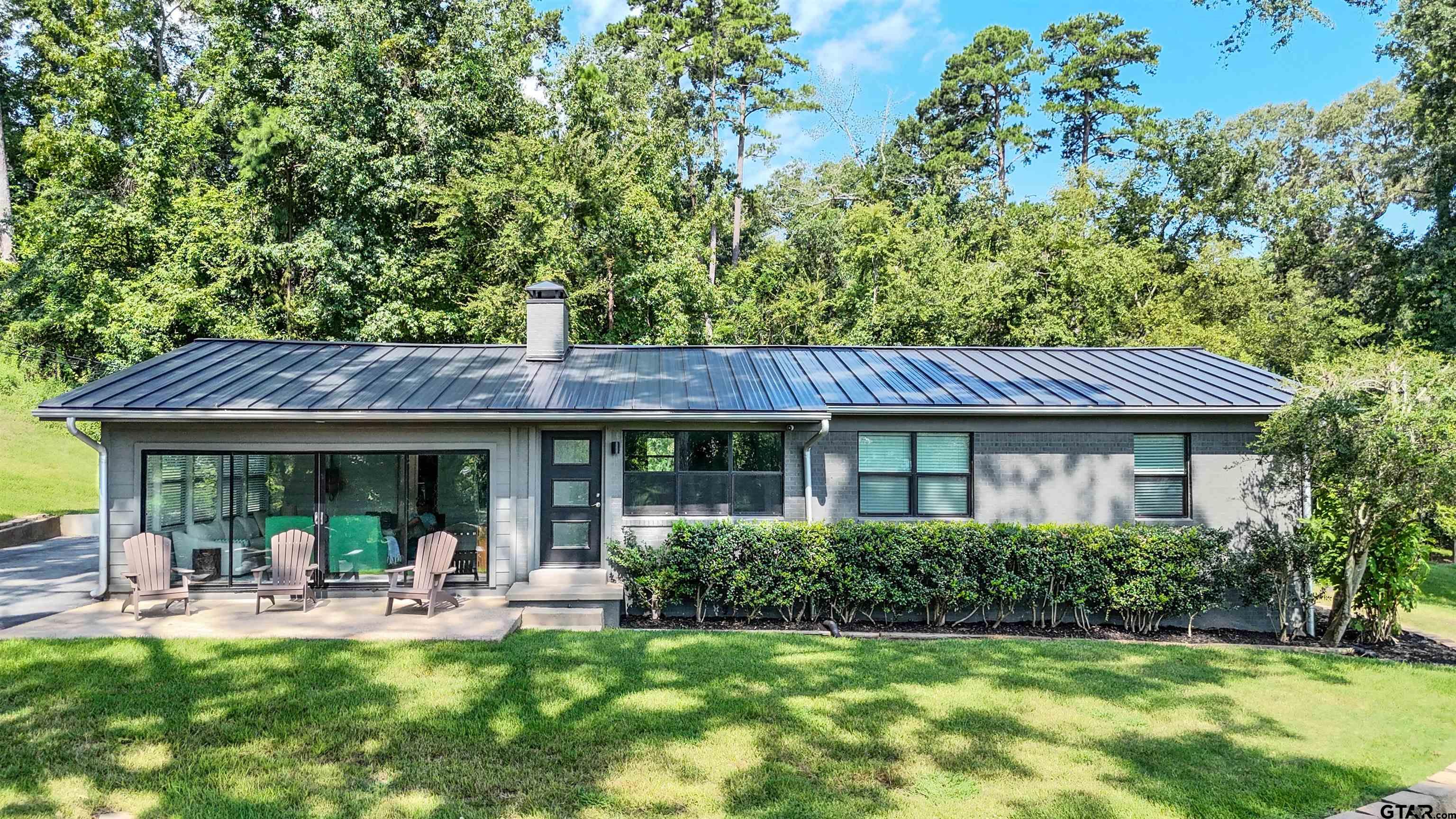 15807 North Peninsula Road Whitehouse, TX 75791 - Photo 3 of 44 a view of a house with backyard and sitting area