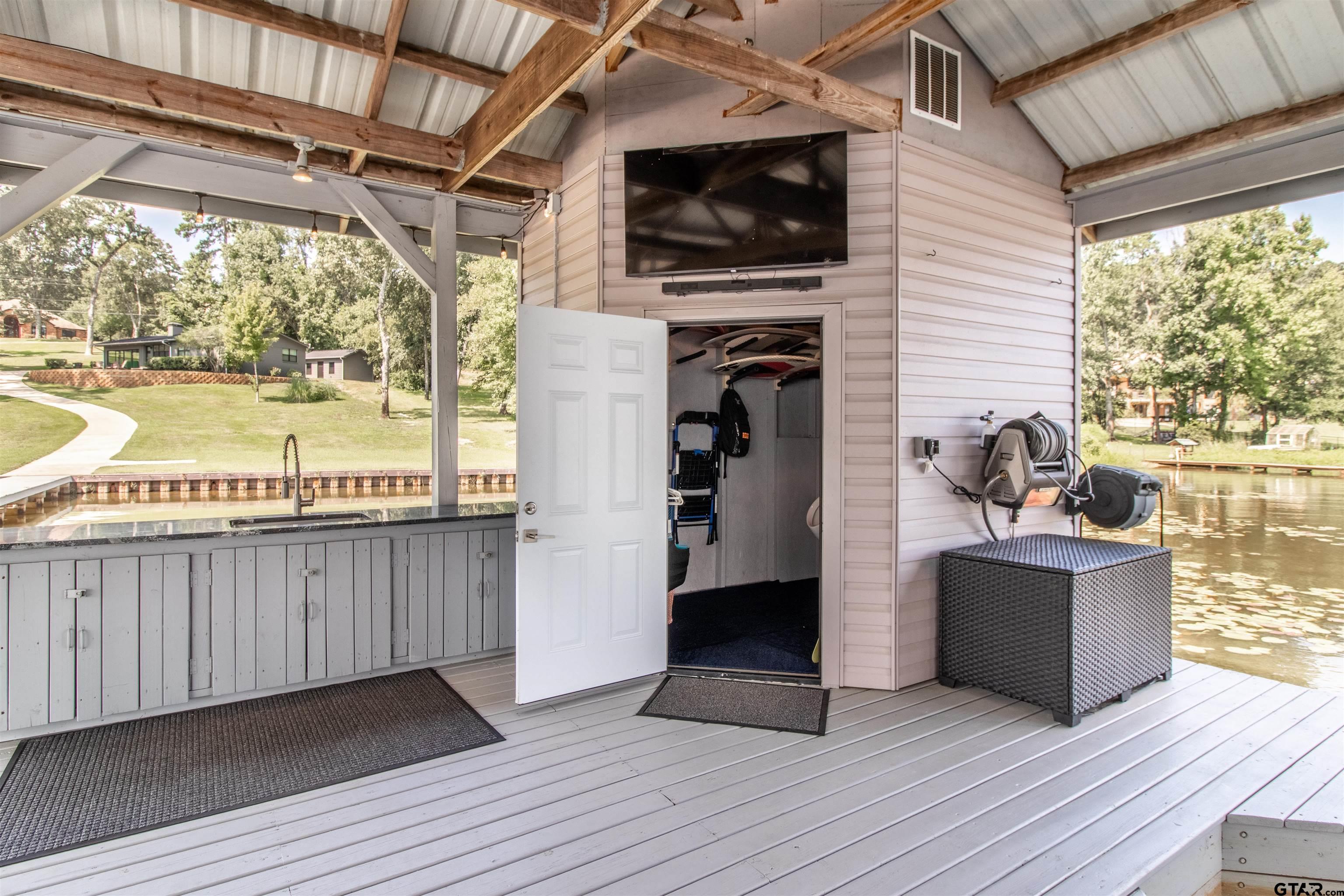 15807 North Peninsula Road Whitehouse, TX 75791 - Photo 36 of 44 a living room with furniture and a flat screen tv