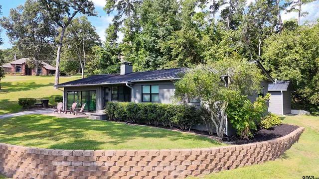 a view of a house with a yard porch and sitting area