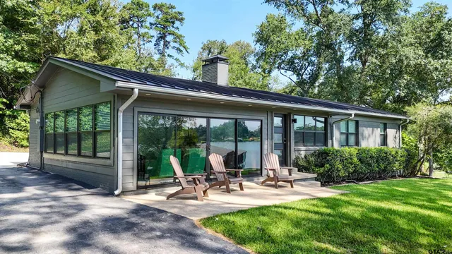 a view of a patio with chairs and floor to ceiling window