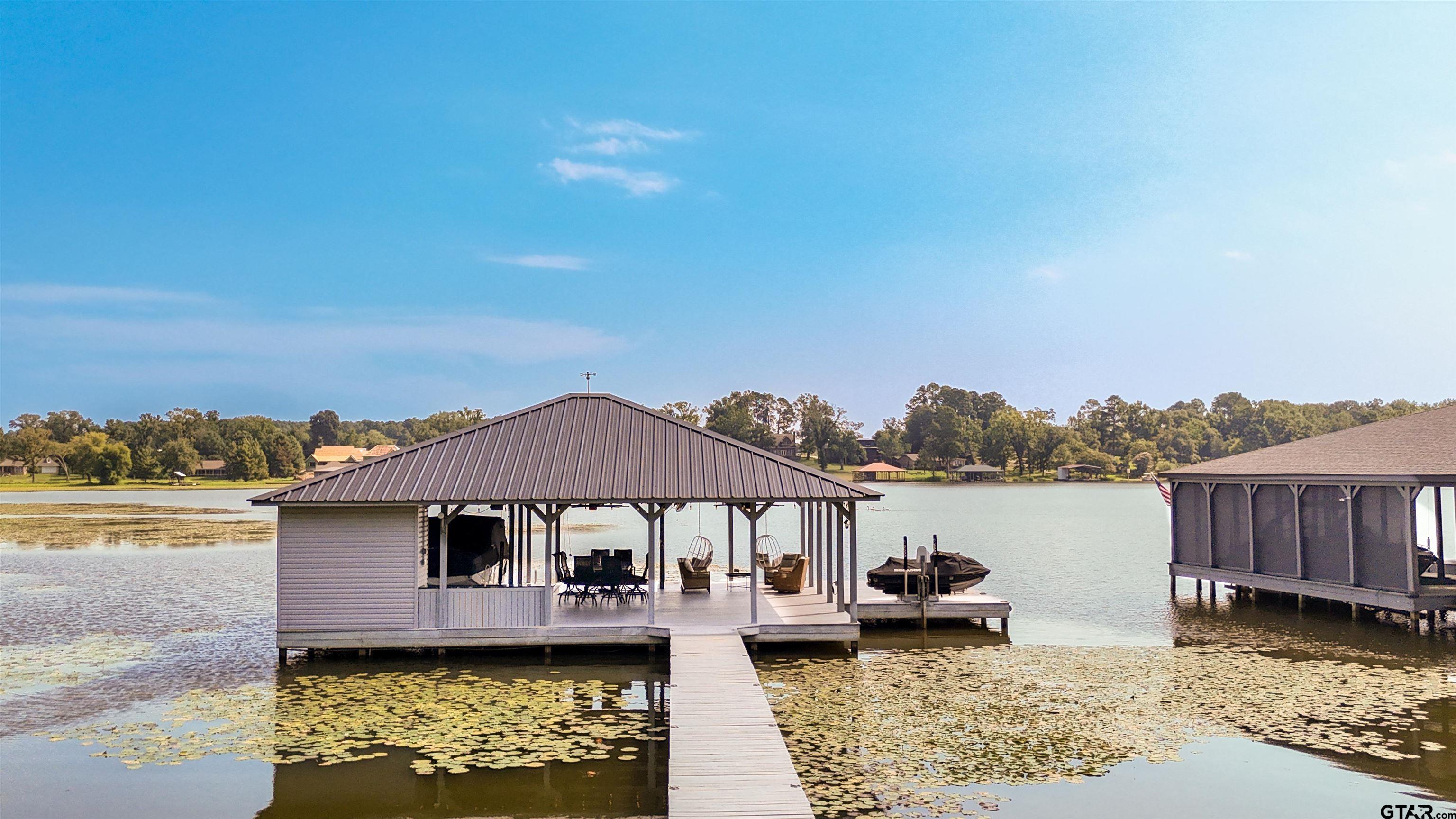 15807 North Peninsula Road Whitehouse, TX 75791 - Photo 7 of 44 a view of a house with wooden floor and a lake view