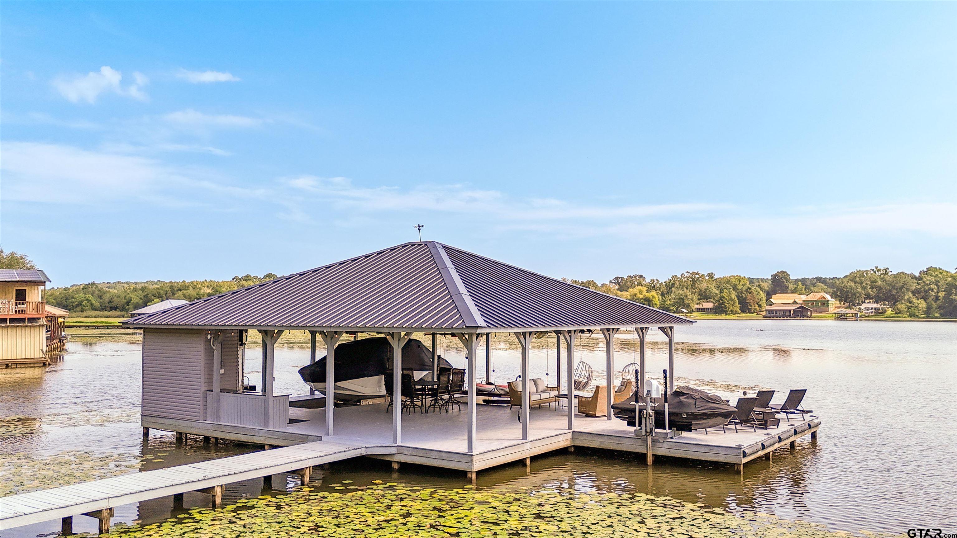 15807 North Peninsula Road Whitehouse, TX 75791 - Photo 8 of 44 a small pool with lawn chairs under an umbrella
