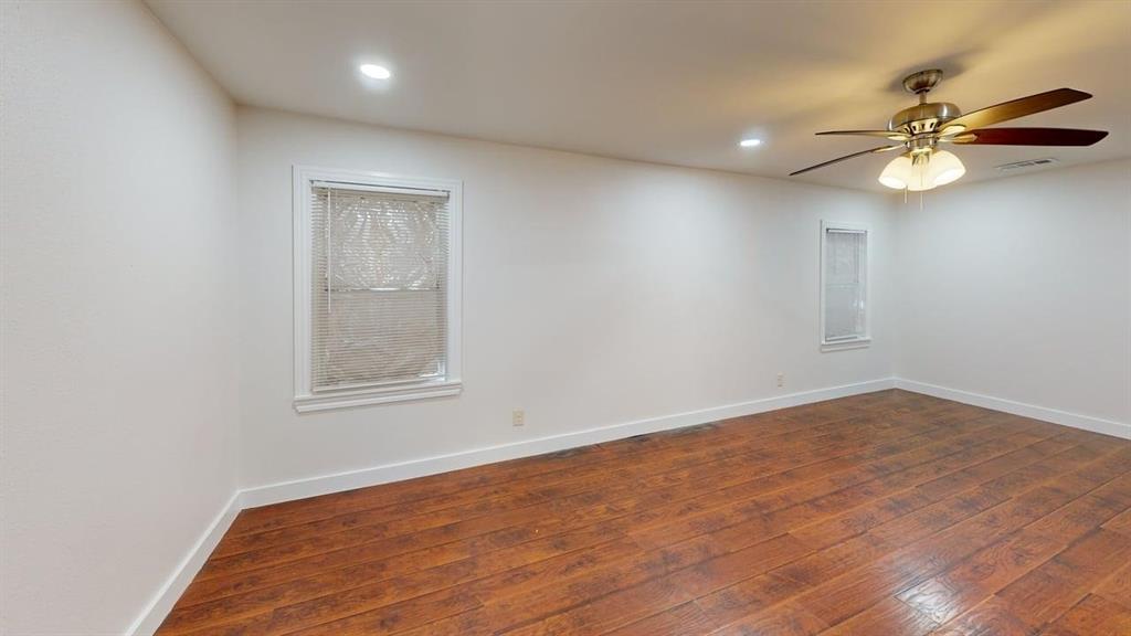 2246 Anson Road Dallas, TX 75235 - Photo 12 of 20 Spacious room featuring wood-finish flooring, white walls, and bright recessed lighting