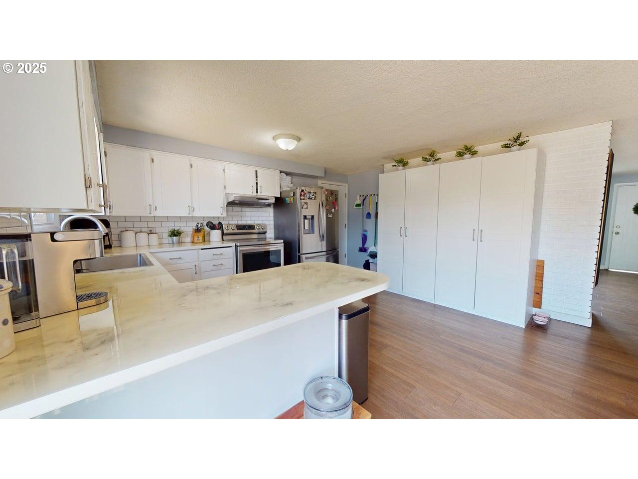 2130 Yolanda Avenue Springfield, OR 97477 - Photo 18 of 30 a kitchen with kitchen island a stove a refrigerator a sink a dining table and chairs