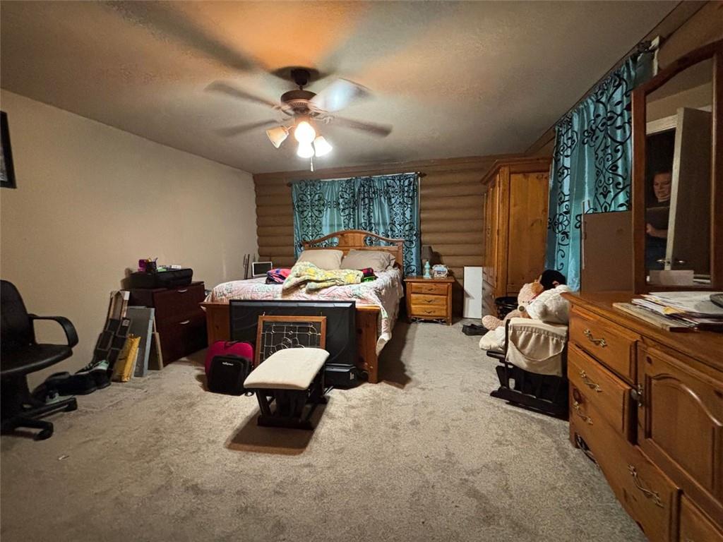 4926 Maroney Mill Road Douglasville, GA 30134 - Photo 12 of 26 a bed room with a bed furniture and a flat screen tv