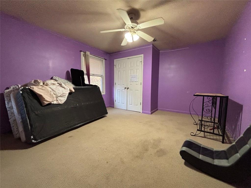 4926 Maroney Mill Road Douglasville, GA 30134 - Photo 16 of 26 a bedroom with a bed and a ceiling fan