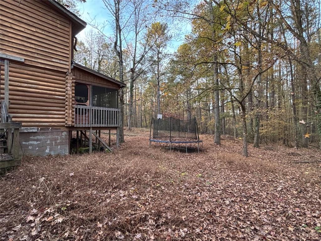 4926 Maroney Mill Road Douglasville, GA 30134 - Photo 23 of 26 a backyard of a house with toys and wooden fence