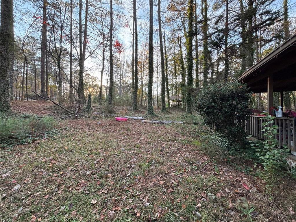 4926 Maroney Mill Road Douglasville, GA 30134 - Photo 24 of 26 a backyard of apartments with large trees
