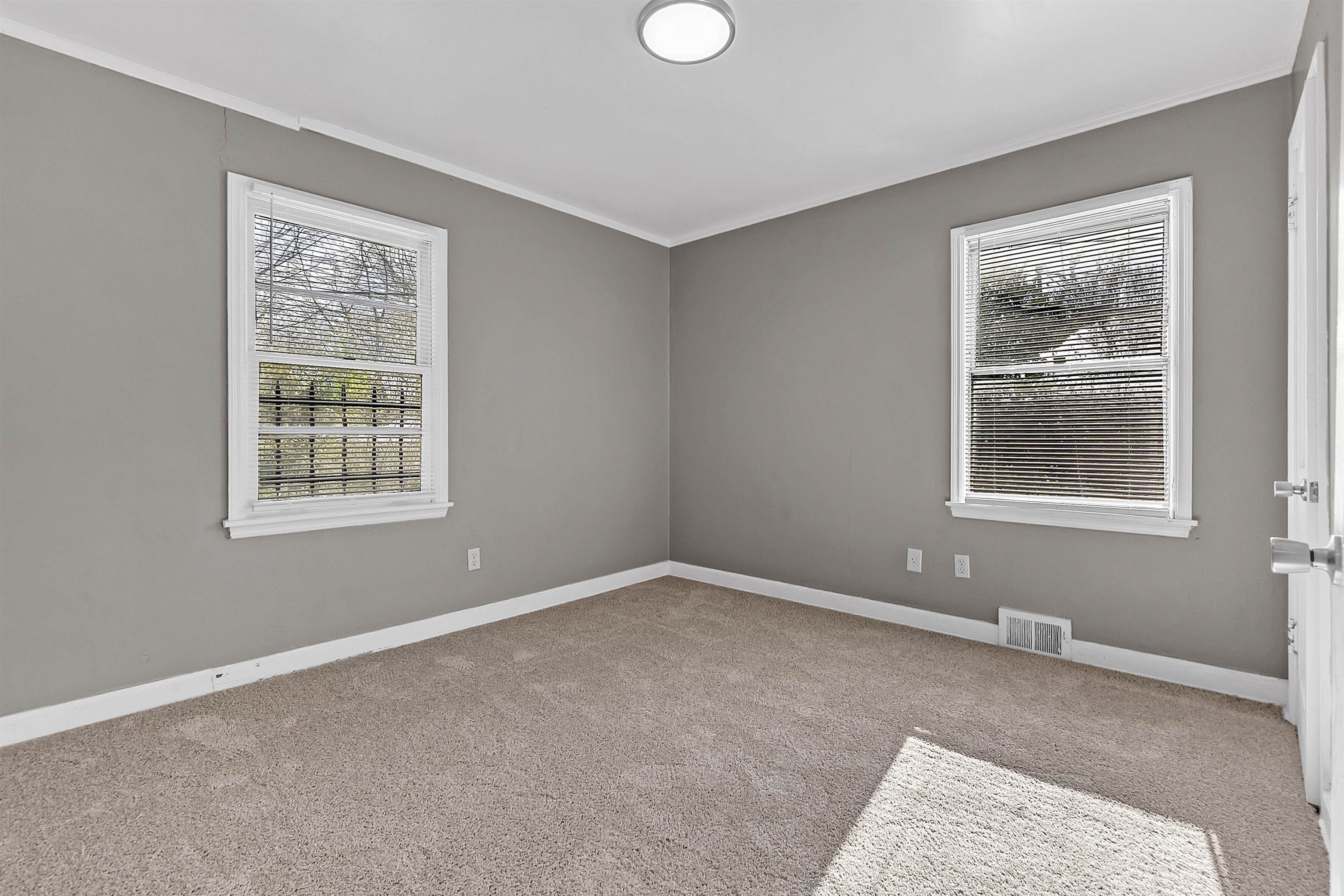 1526 Railton Road Memphis, TN 38111 - Photo 13 of 22 Spare room with light carpet, ornamental molding, and plenty of natural light