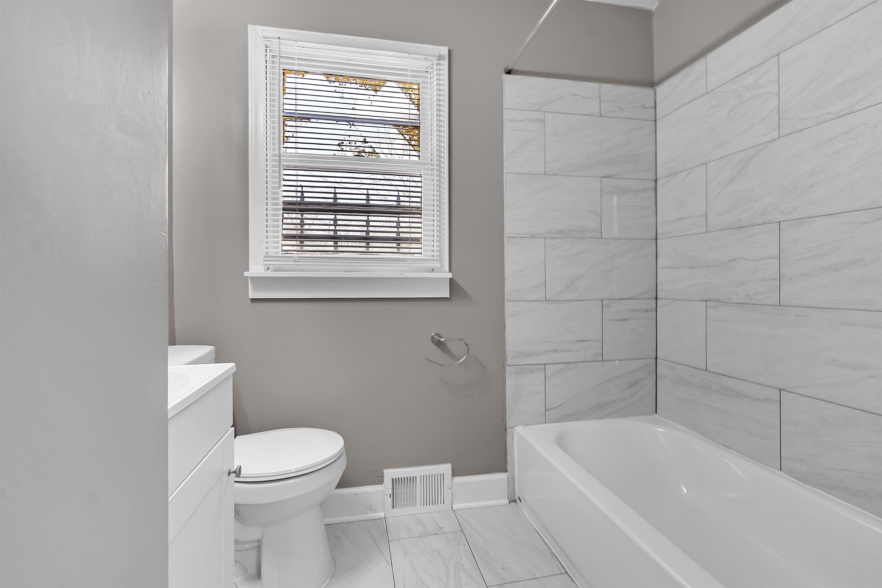 1526 Railton Road Memphis, TN 38111 - Photo 14 of 22 Full bathroom featuring vanity, shower / tub combination, and light marble finish flooring