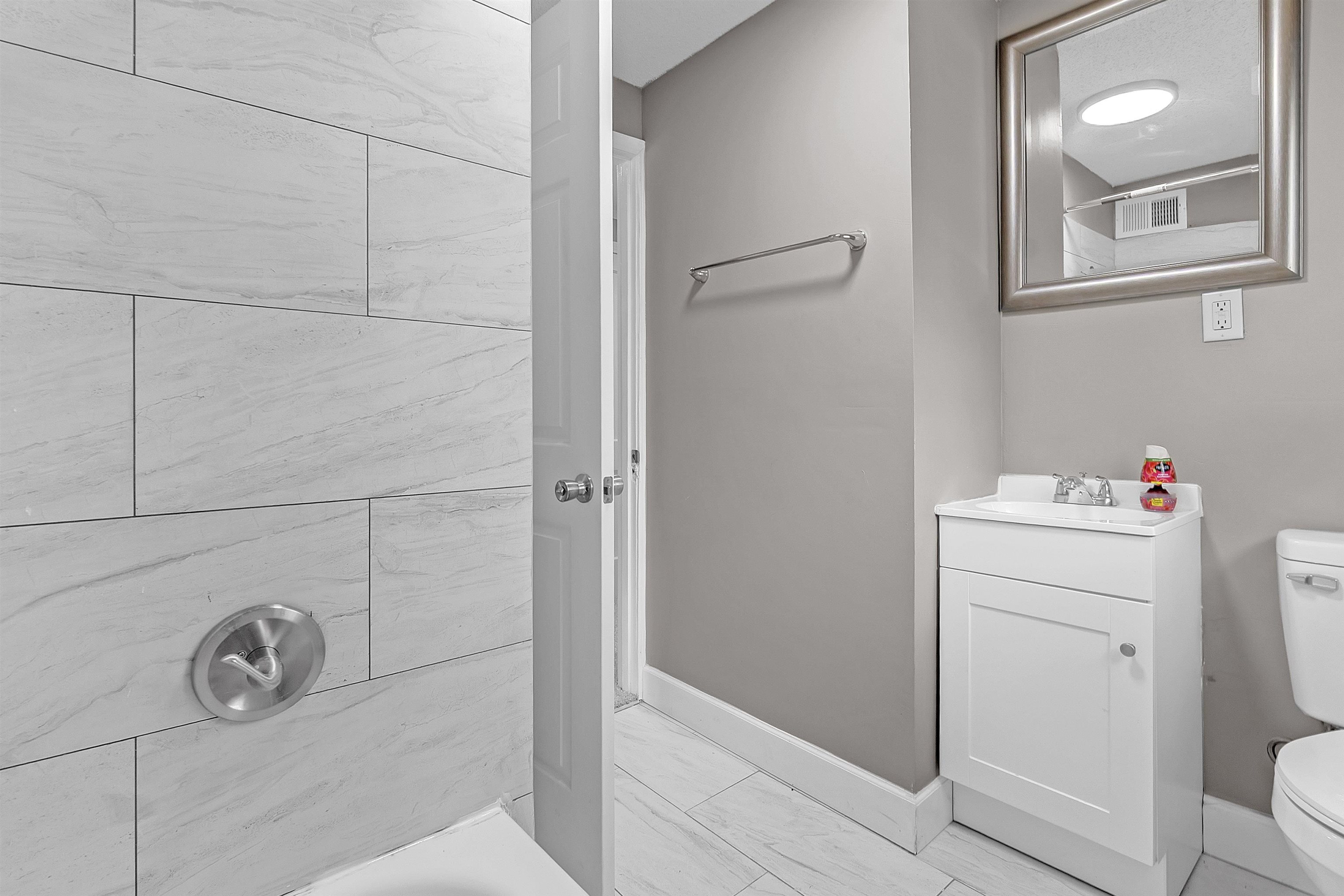 1526 Railton Road Memphis, TN 38111 - Photo 17 of 22 Bathroom featuring vanity, shower / washtub combination, and light marble finish floors