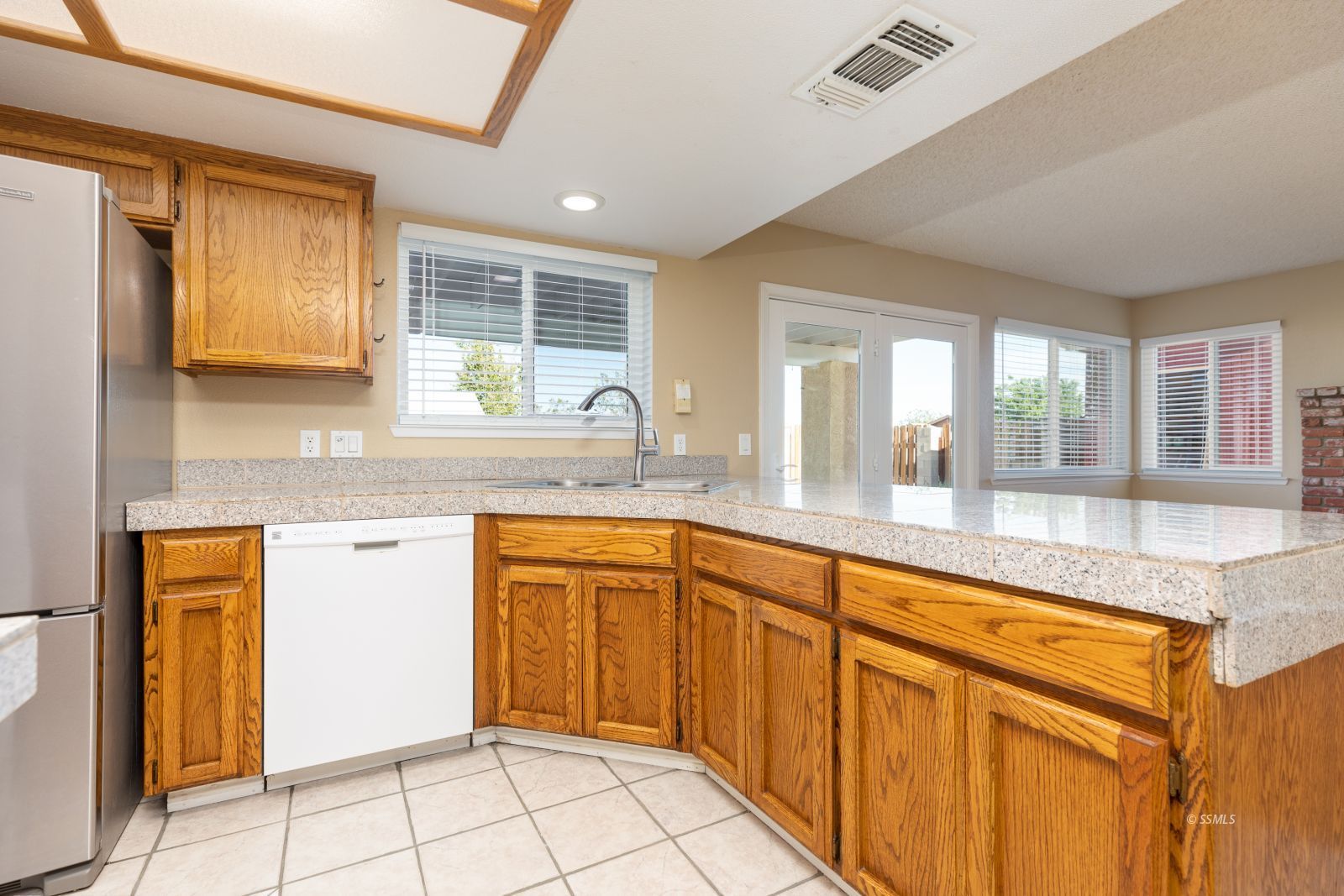 428 North Kern Street Ridgecrest, CA 93555 - Photo 9 of 30 a large kitchen with granite countertop a sink window and cabinets