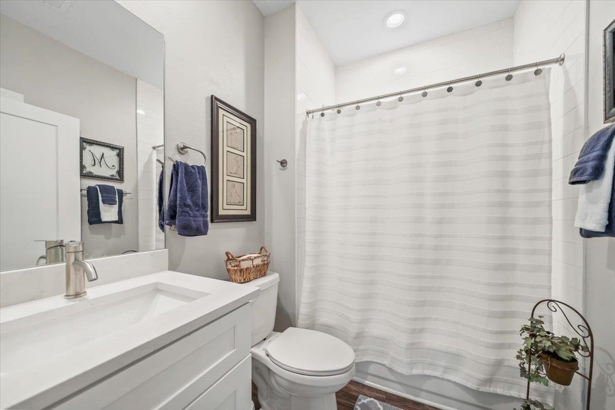 415 Abbey Road, Unit D Munford, TN 38058 - Photo 23 of 35 Bathroom featuring a white vanity with an integrated sink, brushed nickel faucet, and a large wall mirror