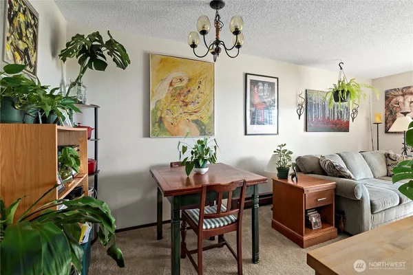 a dining room with furniture and a chandelier