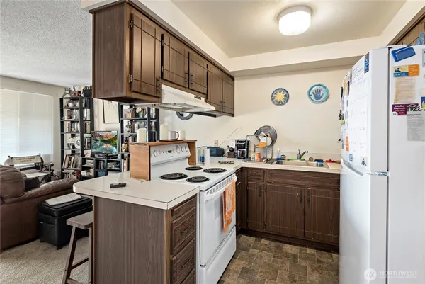 a kitchen with a sink stove and cabinets