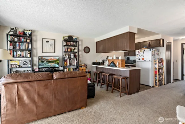 a living room with furniture and a book shelf